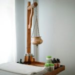 A wooden shelf with bottles and a wooden mannequin on it sensory tools, child routine, therapy room
