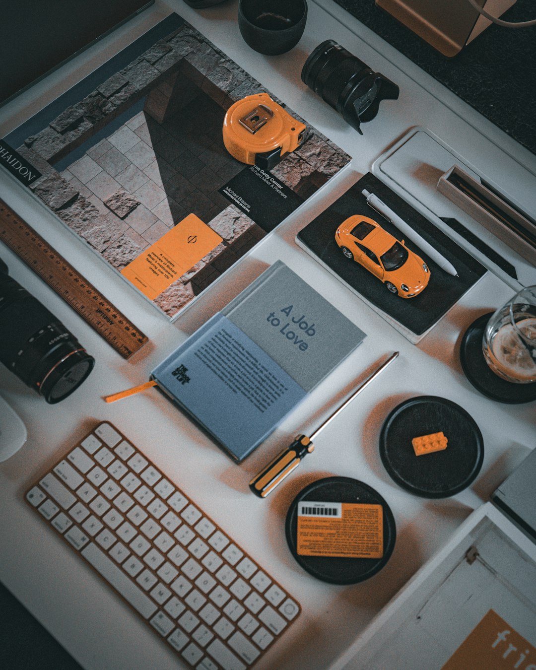 Desk with computer keyboard, cameras, and tools freelance designer, mockups, vector assets, creative desk