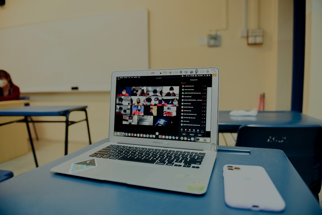 macbook pro on blue table remote proctoring, webcam exam, student verification