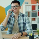 Man in glasses talking on phone at desk admin audit, connected services, workspace security