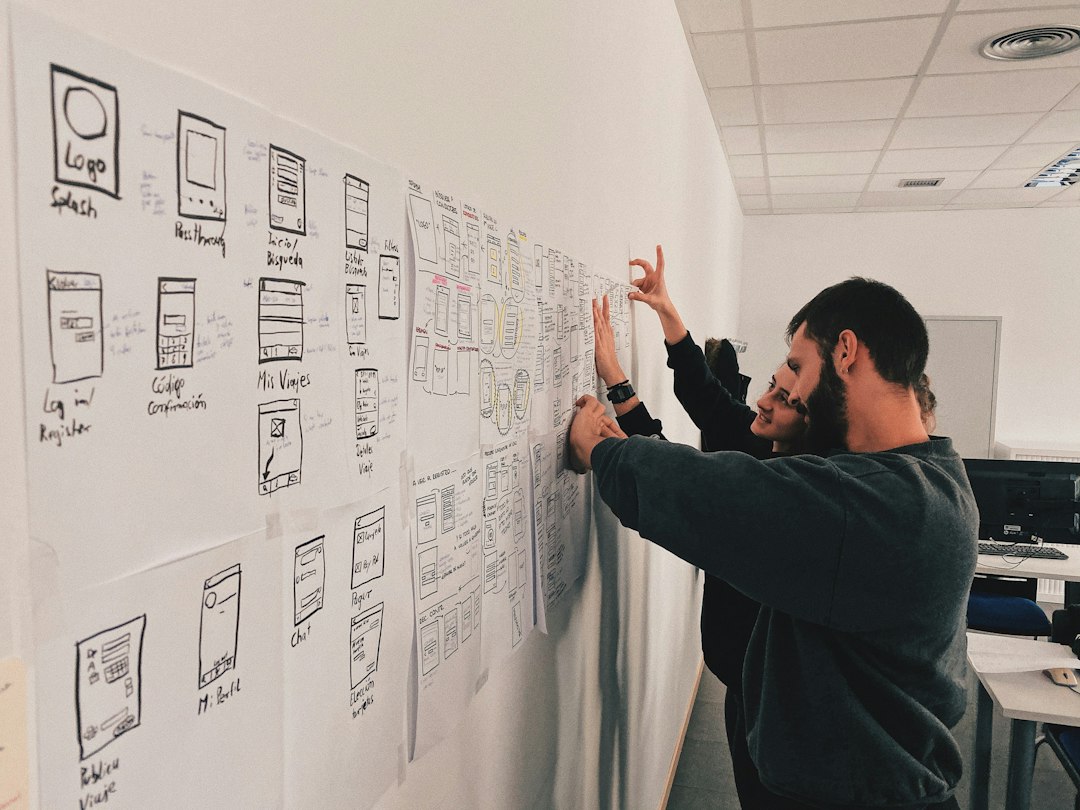 man in gray sweater standing beside wall product design, quality process, engineering team