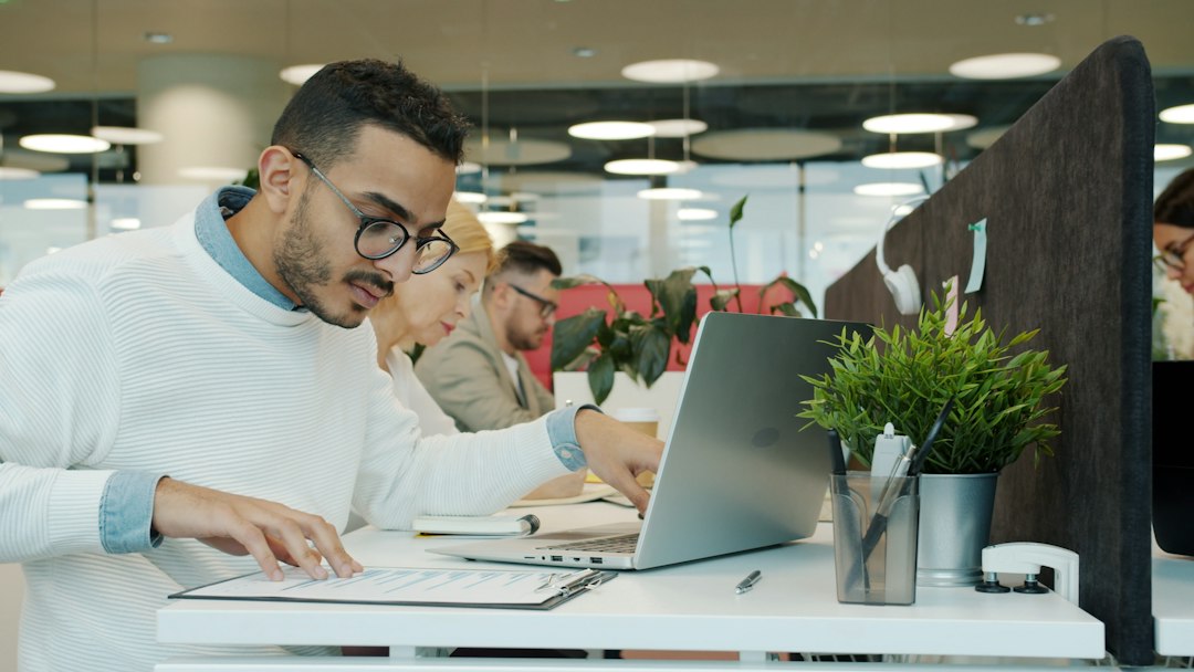 Man working at a desk in an office career growth, project management, office success