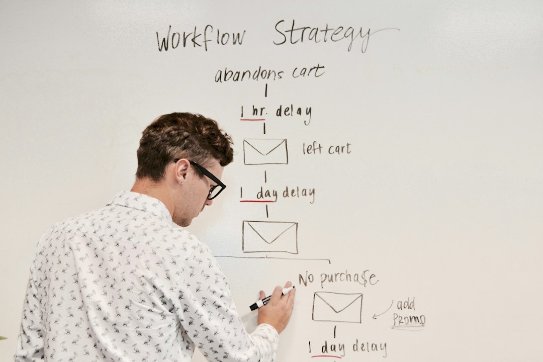 man writing on white board email tags, customer segments, marketing workflow