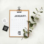 minimalist photography of a calendar wit green leaves february email calendar, newsletter planning, marketing desk