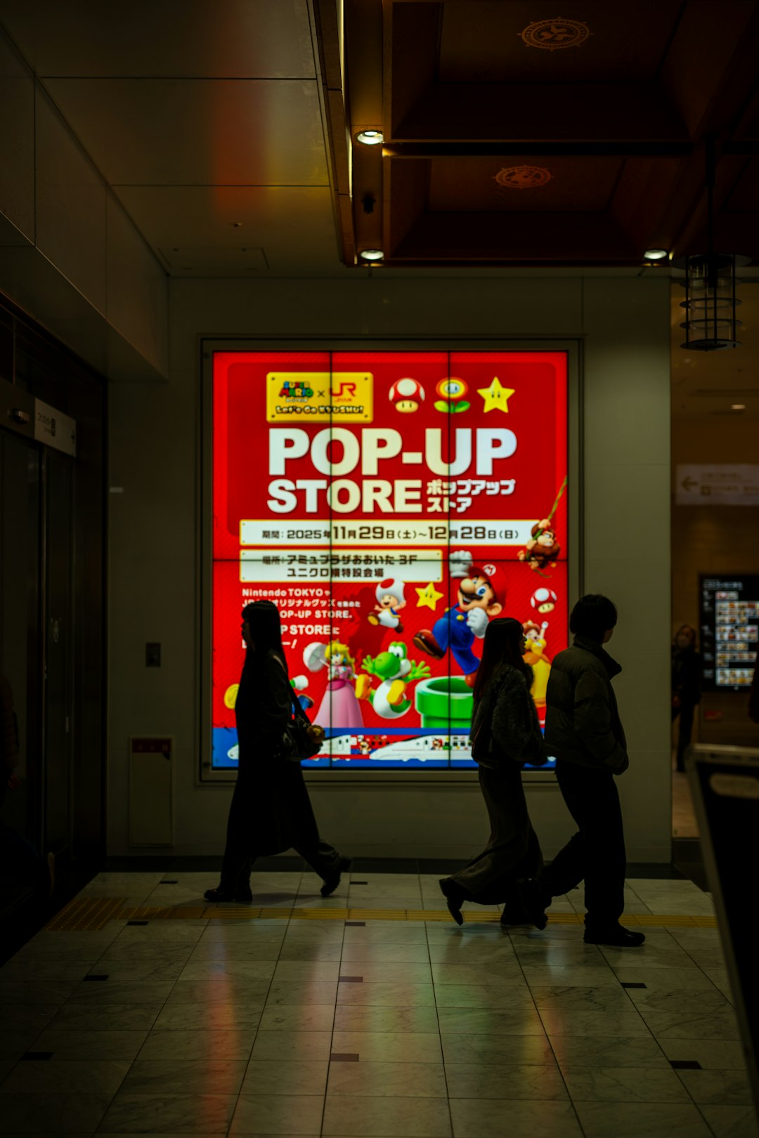 People walk past a bright pop-up store advertisement game store scam, fake code, online warning
