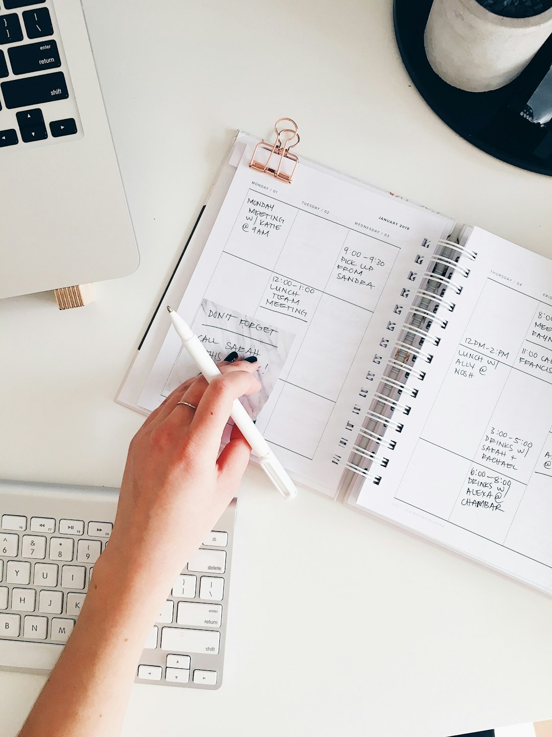 person holding notepad and pen flat lay photography content calendar, search intent, editorial planning