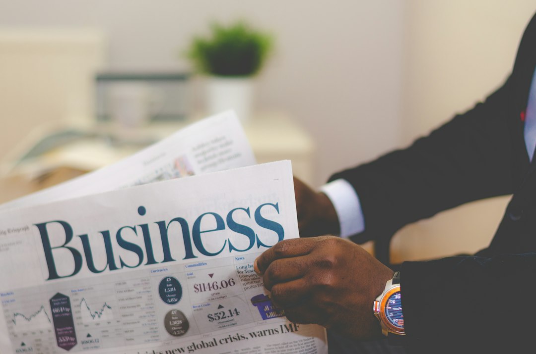 person wearing suit reading business newspaper business continuity, vendor transition, enterprise planning