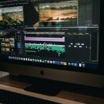 silver iMac turned on beginner video editing, laptop timeline, simple interface