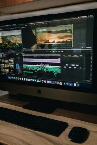 silver iMac turned on beginner video editing, laptop timeline, simple interface