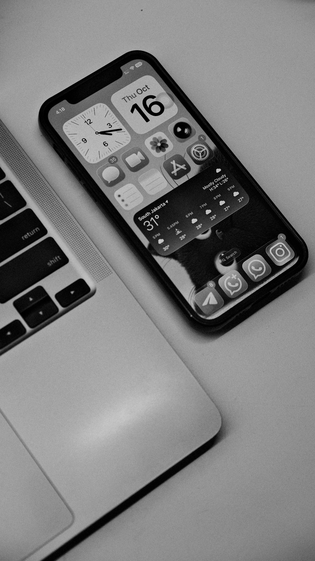 Smartphone and laptop on a flat surface workspace apps, phone productivity, travel work, notes comparison