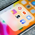 Social media app icons on a smartphone screen with a textured grey background social media gif, reaction clip, sharing platform