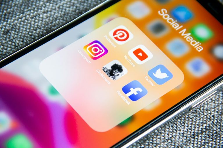 Social media app icons on a smartphone screen with a textured grey background social media gif, reaction clip, sharing platform