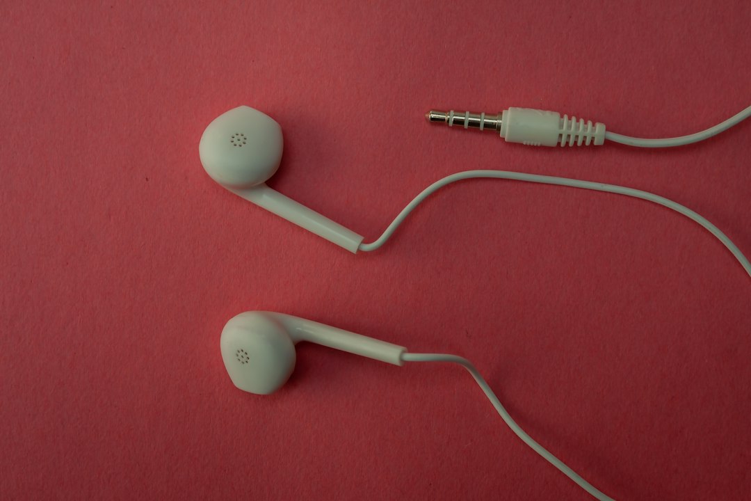 White earbuds and their cable on a pink surface music listening, earbuds, equalizer settings