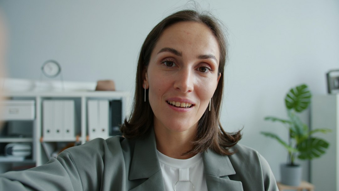 Woman in a suit looking at the camera video call, meeting bot, transcript summary