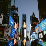 a city street with many billboards corporate crisis newsroom, public relations team, media monitoring