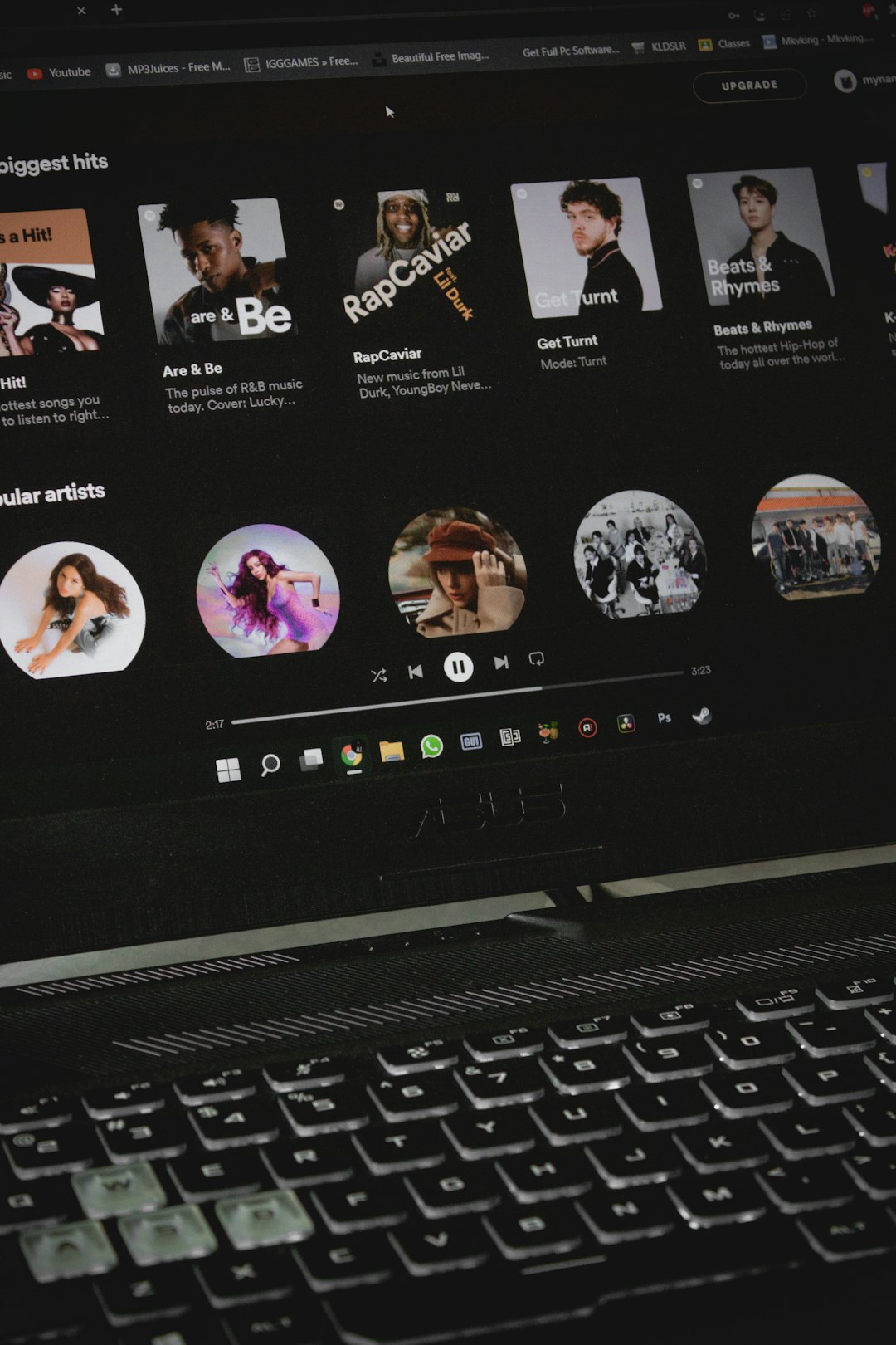a close up of a laptop with a keyboard spotify artist profile music stats