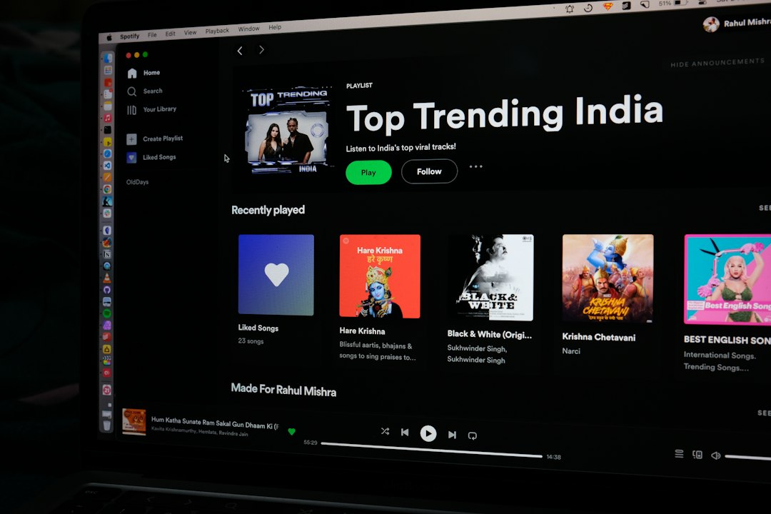 a computer screen with the top trending india logo on it musician laptop spotify upload