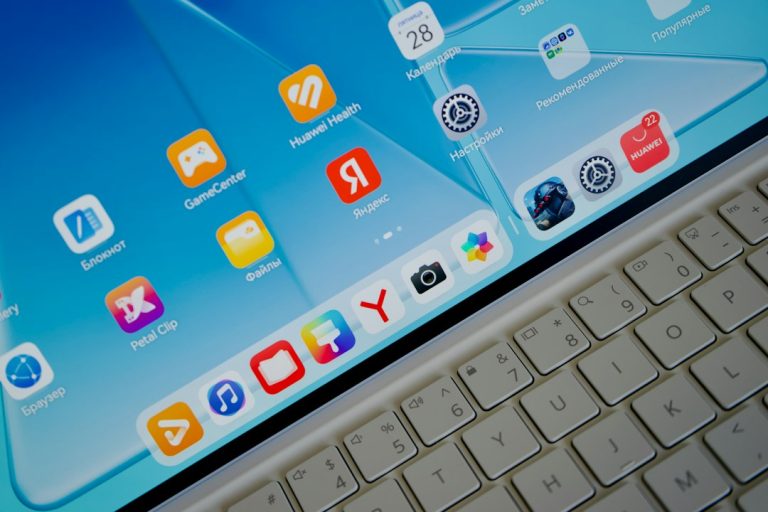 A tablet screen displaying various app icons above a white keyboard music apps comparison, streaming services, desktop icons