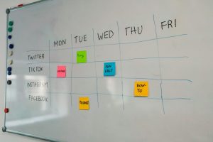 a white board with sticky notes attached to it project timeline, task owners, planning board