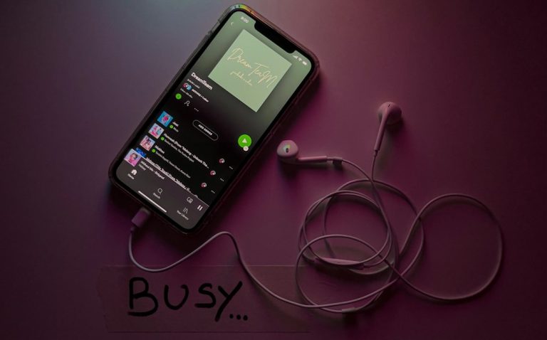 black android smartphone on white surface music app interface, playlist screen, dark theme