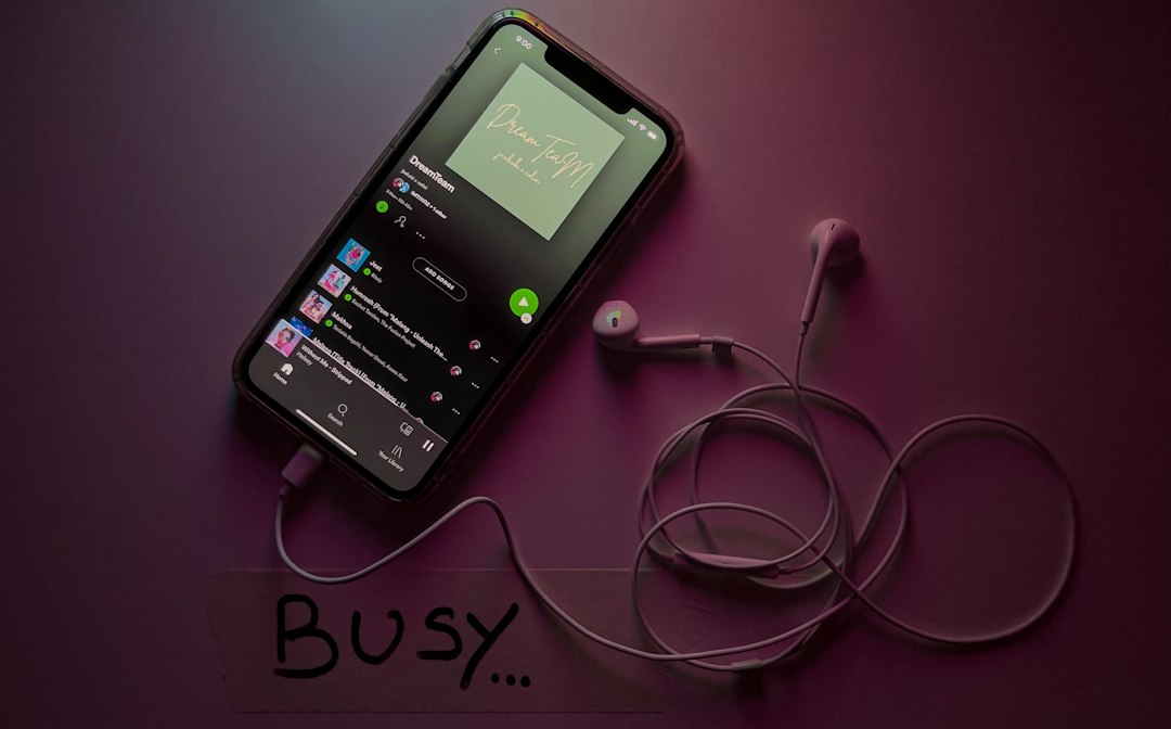 black android smartphone on white surface music app interface, playlist screen, dark theme