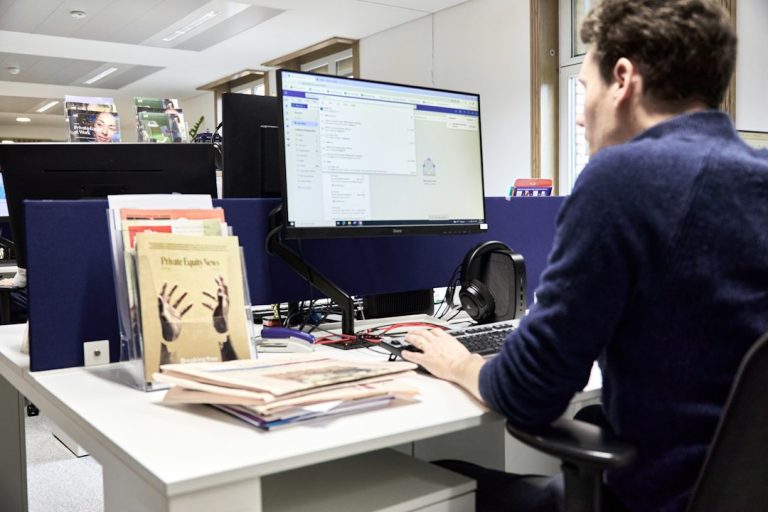 Man working at a computer in an office wordpress staging, website redesign, private workspace