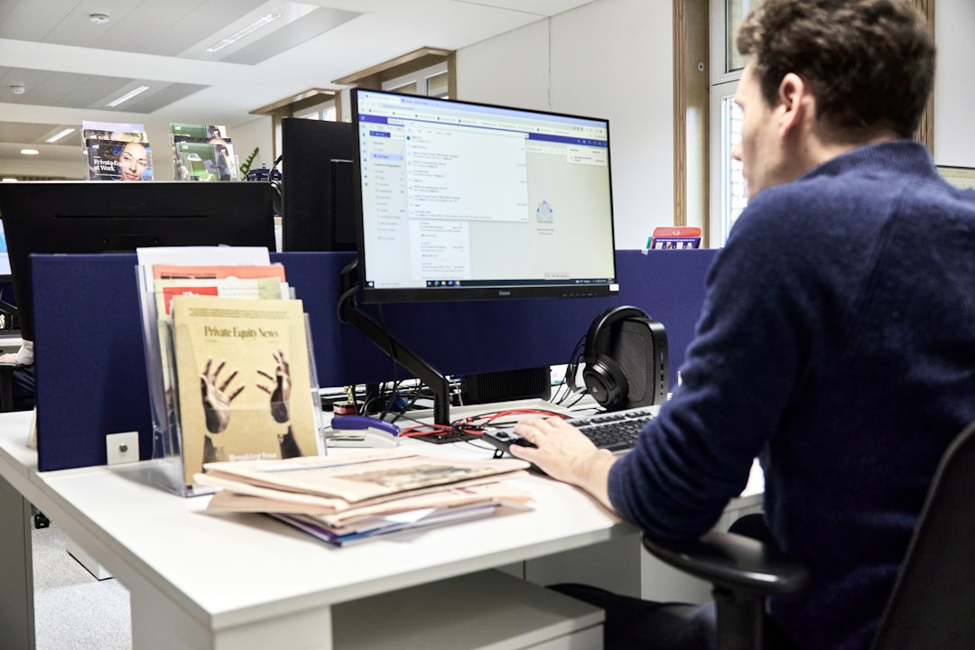 Man working at a computer in an office wordpress staging, website redesign, private workspace