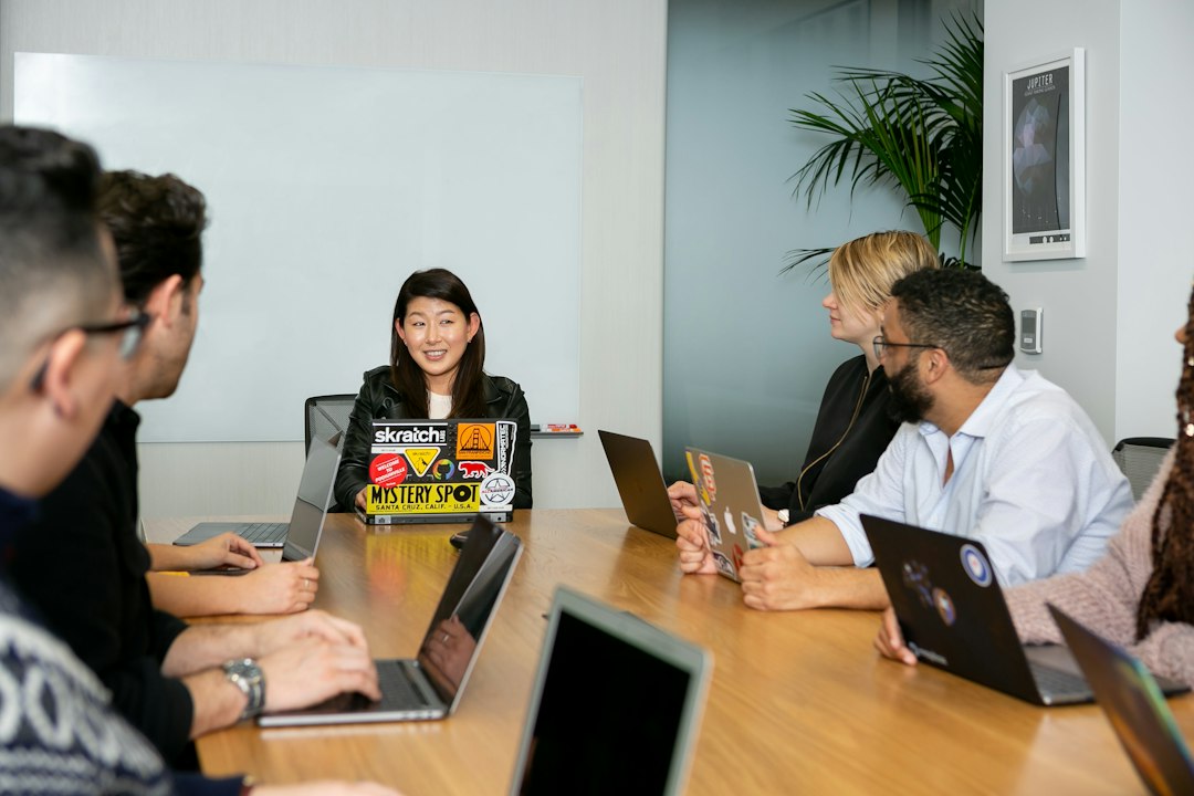 people in a meeting discussing app development kpi report, engagement metrics, executive meeting