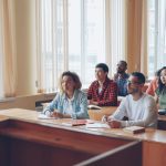 Professor lectures to students in a classroom setting university classroom, exam policy, academic integrity