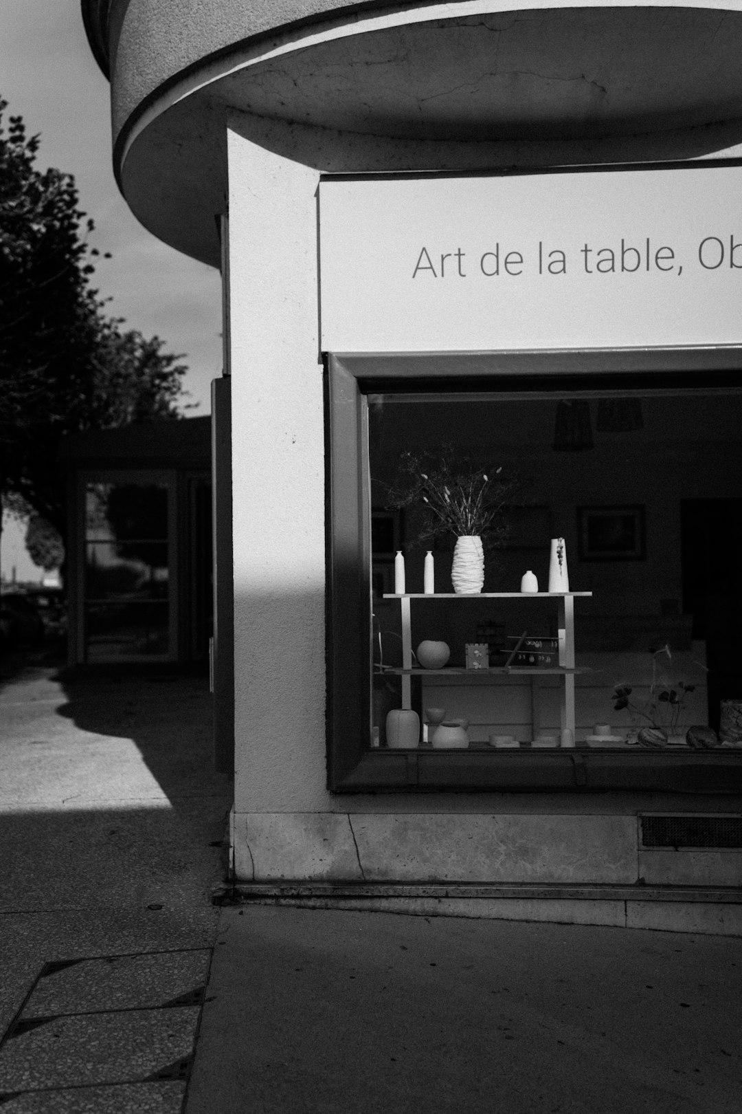 Shop window displaying ceramic art and tableware artist ecommerce shop, handmade products, minimalist storefront