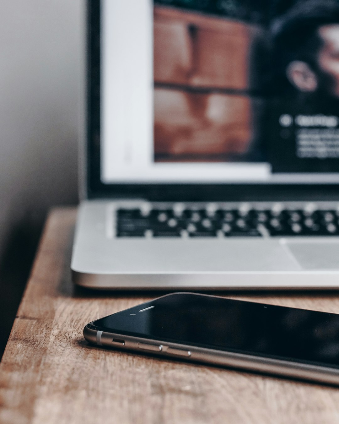 space gray iPhone 6 near MacBook Pro desktop website, mobile plans, customer support
