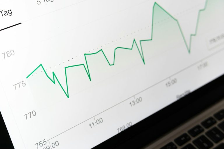 stock market chart displayed on laptop screen marketing analytics chart, customer segments, ecommerce reports, revenue trends