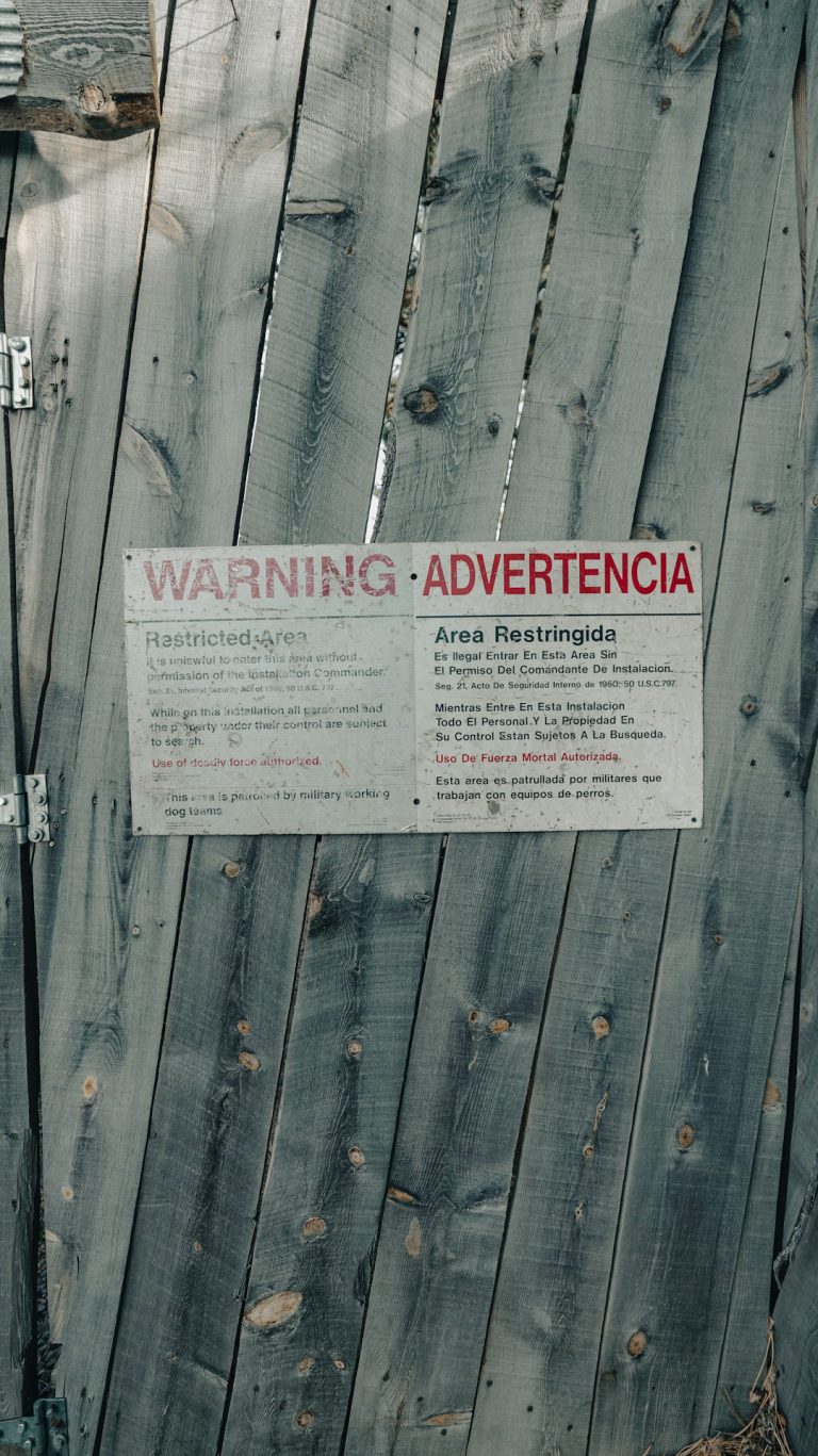 Wooden gate with a warning sign rejected ad warning, policy review, red alert
